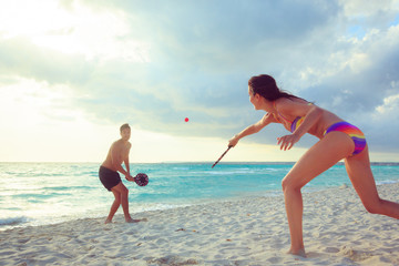 Young Couple Playing Beach Tennis