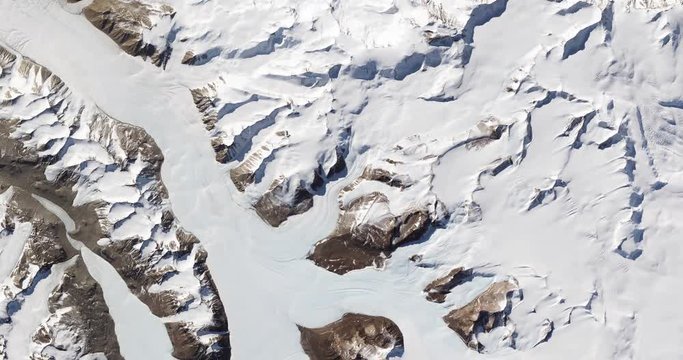 High-altitude overflight aerial of rock outcrops and bare valleys around Taylor Glacier, Antarctica. Clip loops and is reversible. Elements of this image furnished by USGS/NASA Landsat