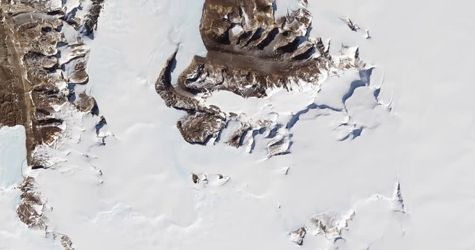 High-altitude overflight aerial of rock outcrops and bare valleys around Taylor Glacier, Antarctica. Clip loops and is reversible. Elements of this image furnished by USGS/NASA Landsat
