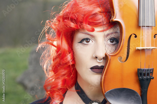 Redhead Woman In A Black Gothic Dress Playing Violin