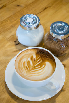 A Cup of coffee on the wooden table background