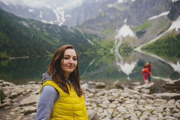 Naklejka premium woman relaxing on the lake and mountains sunny landscape