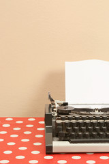 Vintage style portable typewriter with blank sheet 