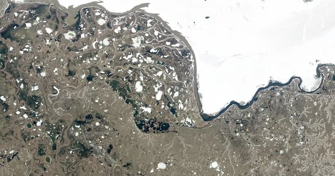 High-altitude overflight aerial of the Taz River, western Siberia, Russia. Clip loops and is reversible. Elements of this image furnished by USGS/NASA Landsat