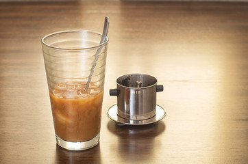 Vietnamese ice coffee with condensed milk, cafe sua da on a wood