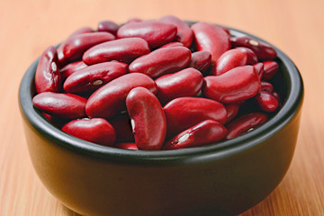 Dry red kidney beans in black bowl