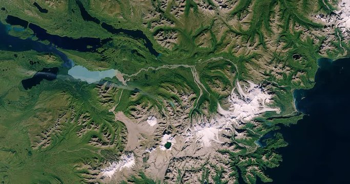 High-altitude overflight aerial of the mountains of Katmai National Park, Alaska. Clip loops and is reversible. Elements of this image furnished by USGS/NASA Landsat