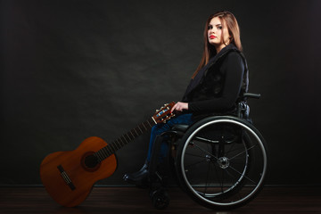 Fototapeta na wymiar Sad disabled girl with guitar.