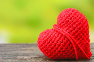 Red heart on wooden table