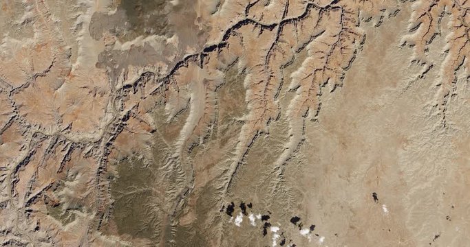 High-altitude overflight aerial of the Grand Canyon and adjacent land, Arizona. Clip loops and is reversible. Elements of this image furnished by USGS/NASA Landsat