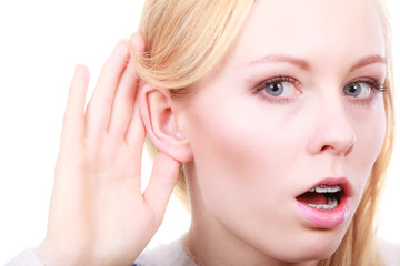 Fototapeta premium Woman listening carefully with hand close to ear
