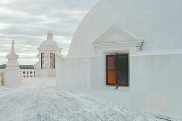 Colorful window on white roof