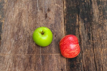 red and green apple on wooden background