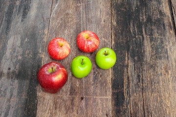 red and green apple on wooden background