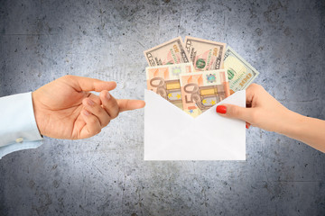 Give a money envelope to a business man as a bribe or financial reward