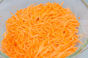 Grated carrots in a glass cup