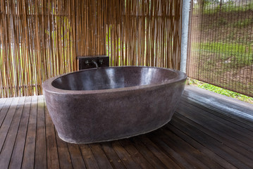 Open air bathroom, Marble bathtub with Bamboo backdrop and Wooden floor