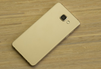 Smartphone on wooden background