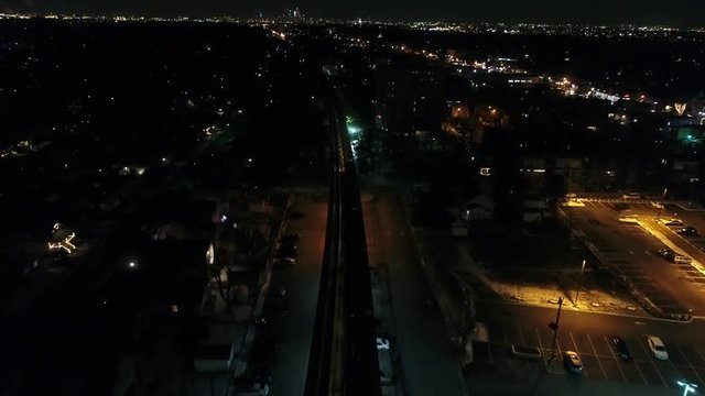 Night Aerial View Flying towards Philadelphia with Patco High Speed Line Train