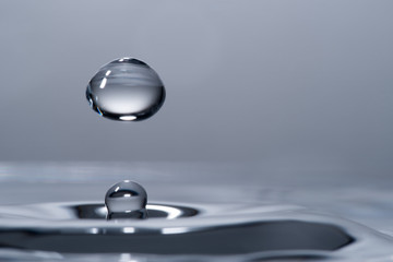 High speed macro from a waterdrop, splashing back again in the water, creating figurine like glass sculptures.
