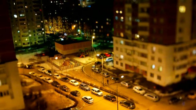 ODINTSOVO, RUSSIA - October 20, 2015. Timelapse clip of night street life. Aerial view of apartment buildings, parking cars and passerby.