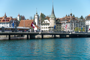 Fototapeta na wymiar View of Lucerne lake and town with Swiss alps from a ferry, Switzerland - April, 2016