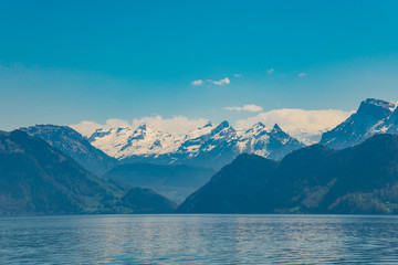 Naklejka na ściany i meble View of Lucerne lake with Swiss alps from a ferry, Switzerland - April, 2016