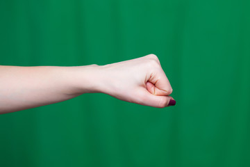 Female fist green background