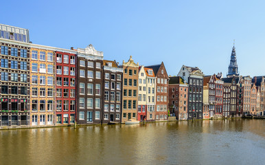 Fototapeta na wymiar Colorful canal houses on the Damrak in the Dutch capital Amsterd