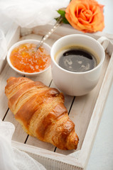 Cup of fresh morning coffee with croissant. Valentine's day concept.