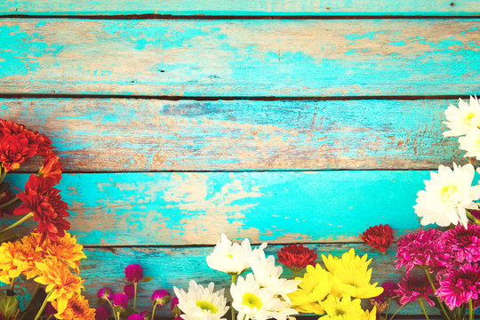 Colorful flowers bouquet on vintage wooden background, border design. vintage color tone - concept flower of spring or summer background