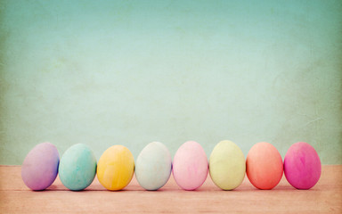 Vintage card of pastel colorful easter eggs on old paper background. Happy easter day background.