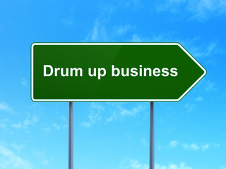 Finance concept: Drum up business on road sign background