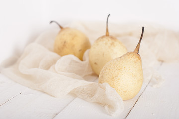 chinese pears on white wooden table