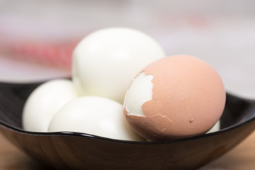 Boiled and pealed eggs served on the black plate