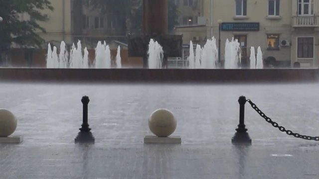 Heavy rain at the city railway station square. Sea port of Novorossiysk.