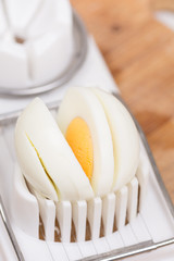 Fototapeta na wymiar Sliced boiled egg on the cutting machine