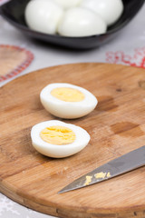 Sliced boiled eggs on the wooden cutting board