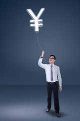 Asian businessman pulling Yen currency