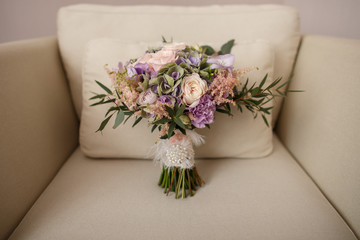 Wedding bouquet, fresh flowers for bridal bouquet in rustic style on beige armchair with copy space. Wedding day concept