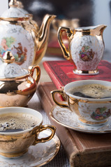Retro porcelain coffee cups with hot espresso and dishware