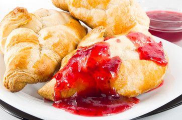 Several croissants with strawberry jam