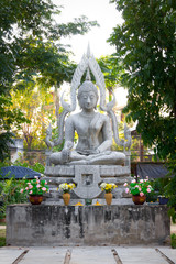 Old white buddha image in the garden