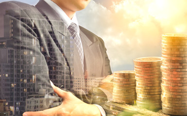 Businessman and stack coins and building shadow success business financial and tax season under the...