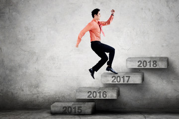 Entrepreneur steps on stairs with number 2017