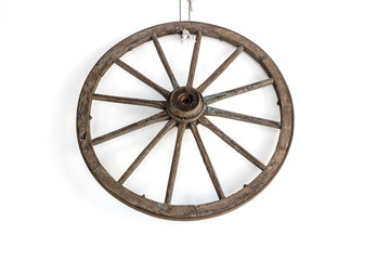 Fototapeta premium Vintage carriage wheel hang on the white wall / Old wooden wheel / Old wheel hang on the white wall background.