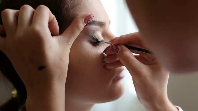 Makeup artist makes a girl beautiful makeup