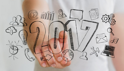 Businessman touching 2017 hand drawn text