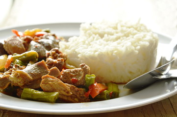 stir fried chicken and mixed entrails with sweet chili eat couple with rice on plate