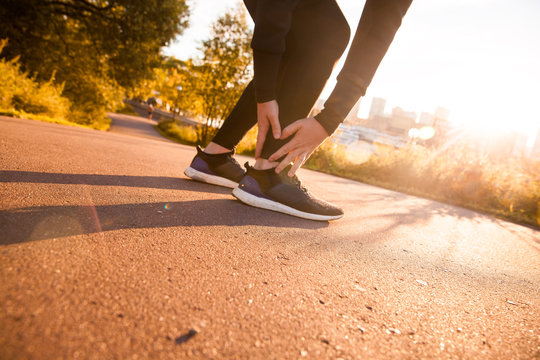 Athletic Man Runner Touching Foot In Pain Due To Sprained Ankle